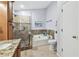 Bathroom featuring walk-in shower, soaking tub, toilet, granite vanity, and neutral colors at 3041 Avalon Terrace Dr, Valrico, FL 33596