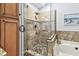 Bathroom featuring a shower with mosaic floor and stone tile surround and glass door at 3041 Avalon Terrace Dr, Valrico, FL 33596