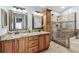 Bathroom with double sink, walk-in shower with glass door and decorative tile details at 3041 Avalon Terrace Dr, Valrico, FL 33596