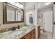 Bathroom featuring granite countertops, wood cabinets, and decorative mirror at 3041 Avalon Terrace Dr, Valrico, FL 33596