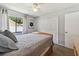 Bedroom with neutral tones, a ceiling fan, and a large window at 3041 Avalon Terrace Dr, Valrico, FL 33596
