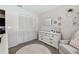 This bedroom offers ample storage with a large closet and a classic white dresser at 3041 Avalon Terrace Dr, Valrico, FL 33596