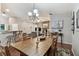 Bright dining room featuring wood table, chandelier, and view of the living room fireplace at 3041 Avalon Terrace Dr, Valrico, FL 33596