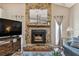 Close up of fireplace with stone mantle, framed art, and mounted television at 3041 Avalon Terrace Dr, Valrico, FL 33596