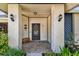 Charming covered front entrance with decorative sconces and a cozy bench at 3041 Avalon Terrace Dr, Valrico, FL 33596