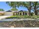 Charming single-story home features an attached garage and a beautifully landscaped front yard with mature trees at 3041 Avalon Terrace Dr, Valrico, FL 33596