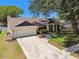 Charming single Gathering home with a well manicured front lawn and two car garage at 3041 Avalon Terrace Dr, Valrico, FL 33596