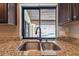 Granite counter top at kitchen sink overlooking the pool view at 3041 Avalon Terrace Dr, Valrico, FL 33596