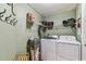 Laundry room with washer and dryer, storage shelves, and hanging rack at 3041 Avalon Terrace Dr, Valrico, FL 33596