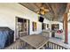 Inviting covered patio with ceiling fans, a barbecue grill, and cozy wicker furniture for relaxing or entertaining at 3041 Avalon Terrace Dr, Valrico, FL 33596