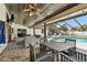 This covered patio features a dining area and a relaxing lounge space near the pool at 3041 Avalon Terrace Dr, Valrico, FL 33596