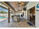 This covered patio includes a lounge area, dining space, and an outdoor kitchen setup at 3041 Avalon Terrace Dr, Valrico, FL 33596