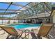 Serene screened-in pool area with sun loungers and outdoor seating for ultimate relaxation and entertaining at 3041 Avalon Terrace Dr, Valrico, FL 33596