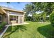Spacious backyard with lush green grass and ample shade, perfect for outdoor activities and relaxation at 3119 Bent Creek Dr, Valrico, FL 33596