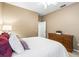 Bedroom with wood dresser and white bedding at 3119 Bent Creek Dr, Valrico, FL 33596