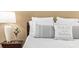 Bedroom with a lamp and bedside table, featuring decorative pillows on a neatly made bed at 3119 Bent Creek Dr, Valrico, FL 33596