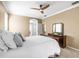 Cozy bedroom with a ceiling fan and a wooden dresser with a decorative mirror at 3119 Bent Creek Dr, Valrico, FL 33596