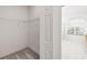 Walk-in closet with wire shelving and an ensuite bathroom with glass shower at 3119 Bent Creek Dr, Valrico, FL 33596