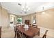 Spacious dining room with dark wood table, chandelier, and access to living area and bedrooms at 3119 Bent Creek Dr, Valrico, FL 33596