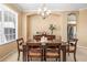 Traditional dining room with dark wood table, upholstered chairs, buffet, and elegant chandelier at 3119 Bent Creek Dr, Valrico, FL 33596