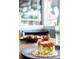 Beautifully plated dish with layered ingredients on a gray plate in this modern dining area at 3119 Bent Creek Dr, Valrico, FL 33596