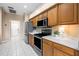 Stainless steel oven and microwave over wooden cabinets and white countertops in bright kitchen at 3119 Bent Creek Dr, Valrico, FL 33596
