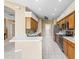 Bright kitchen with white countertops, stainless appliances, tile floor, and wooden cabinets at 3119 Bent Creek Dr, Valrico, FL 33596
