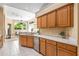 Bright kitchen with stainless appliances and tile floors with a view into the adjacent living area at 3119 Bent Creek Dr, Valrico, FL 33596