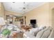 Spacious living room with an open layout, neutral walls, ceiling fan, and views to the dining area and kitchen at 3119 Bent Creek Dr, Valrico, FL 33596