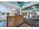 Bright lobby featuring wood paneled walls, ceiling fan, tennis equipment rack, and front desk at 3119 Bent Creek Dr, Valrico, FL 33596