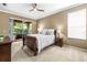 Relaxing main bedroom featuring a ceiling fan, private access to the lanai, and an en-suite bathroom at 3119 Bent Creek Dr, Valrico, FL 33596