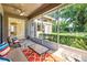 Comfortable screened patio area with an orange rug, perfect for relaxation and entertainment at 3119 Bent Creek Dr, Valrico, FL 33596