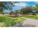 Community playground with green lawns, a variety of play equipment, and mature shade trees at 3119 Bent Creek Dr, Valrico, FL 33596