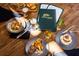 Delicious food options are plated on a wooden table with the River Hills Country Club menu at 3119 Bent Creek Dr, Valrico, FL 33596