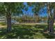 Lush backyard with mature trees and picturesque waterfront views at 3133 Pineview Dr, Holiday, FL 34691
