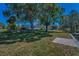 Expansive backyard with mature trees and partial view of the home's exterior at 3133 Pineview Dr, Holiday, FL 34691