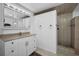 Bathroom with a walk-in shower, large mirror and a beige-tiled floor at 3133 Pineview Dr, Holiday, FL 34691