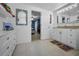 Spacious bathroom with white cabinets and access to a bedroom at 3133 Pineview Dr, Holiday, FL 34691