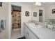 Bathroom with a white sink and vanity, mirror, and a shower with a patterned curtain at 3133 Pineview Dr, Holiday, FL 34691