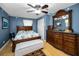 Charming bedroom with a decorative dresser and a large window, creating a relaxing space at 3133 Pineview Dr, Holiday, FL 34691