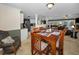 Dining area with wooden table, seating for six, and views into the kitchen and living spaces at 3133 Pineview Dr, Holiday, FL 34691