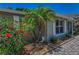 Beautiful exterior detail with red hibiscus, small palm trees and accent stones at 3133 Pineview Dr, Holiday, FL 34691