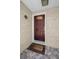 Inviting front door with decorative window and a welcome mat on a tiled porch at 3133 Pineview Dr, Holiday, FL 34691