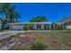 Inviting single-story home with a brick facade, two-car garage, and well-kept landscaping at 3133 Pineview Dr, Holiday, FL 34691