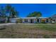 Charming single-story home with well-maintained lawn, brick facade, and beautiful landscaping at 3133 Pineview Dr, Holiday, FL 34691
