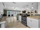 Spacious kitchen featuring stainless steel appliances, white cabinetry, and an open design concept at 3133 Pineview Dr, Holiday, FL 34691