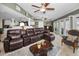 Open-concept living area with tile floors, ceiling fans, and a comfortable sectional sofa at 3133 Pineview Dr, Holiday, FL 34691
