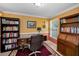 Home office with bookshelves, desk, and a large rug creating a stylish workspace at 3133 Pineview Dr, Holiday, FL 34691