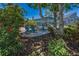 Backyard seating area with lush landscaping and privacy at 3133 Pineview Dr, Holiday, FL 34691