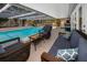 Inviting screened-in pool with comfortable wicker patio furniture and scenic views at 3133 Pineview Dr, Holiday, FL 34691